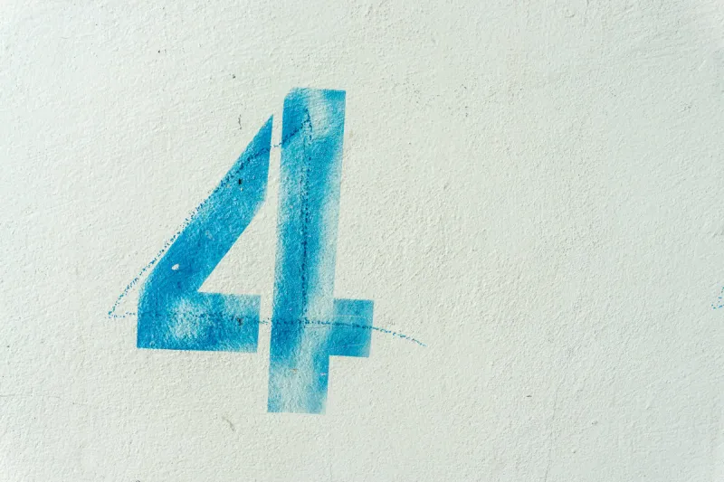 the number 4 on the dirty white wall
