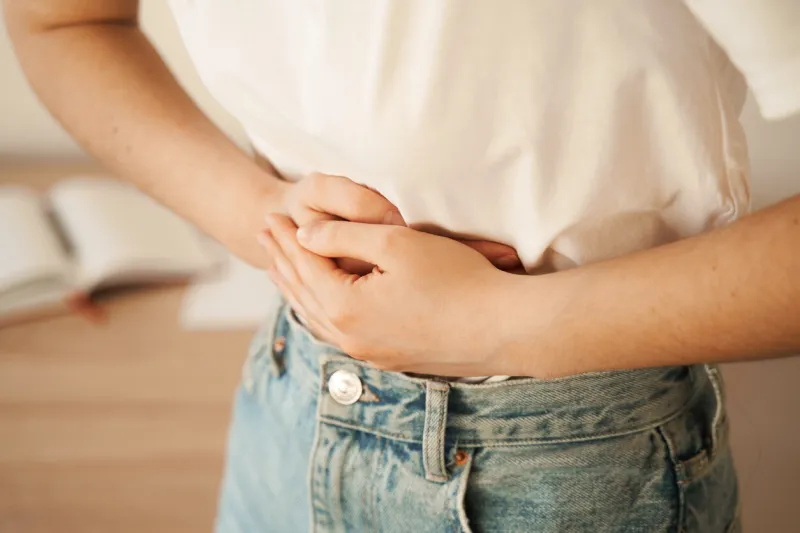 stomach pain gastritis is an inflammation, irritation, or erosion of lining of stomach sick girl hold abdomen because it hurts