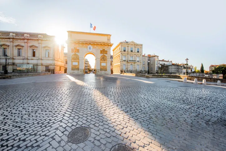 street view with triumphal arch during the sunrise in montpellier city in occitanie region of france