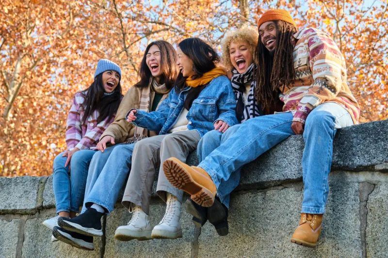 happy playful multiethnic group of young friends bonding outdoors multiracial millennials students meeting in the city, concepts of youth, people lifestyle, diversity, teenage and urban life