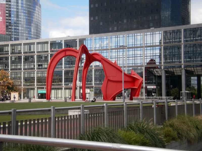 puteaux, france - august 10, 2013  view of the la défense business district, which brings together the headquarters of the largest french companies view of the permanent sculpture the red spider (l'araignée rouge) by alexander calder