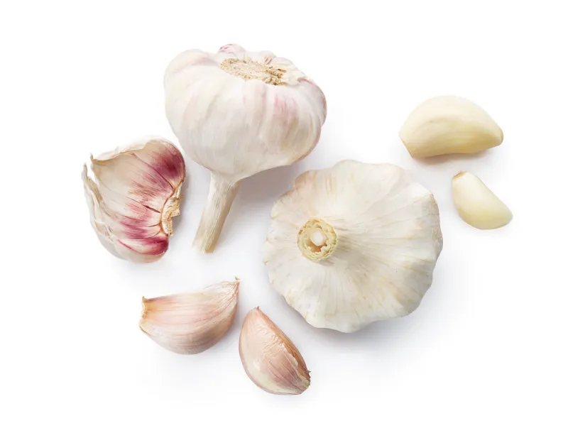 fresh garlic bulbs and cloves isolated on white background top view