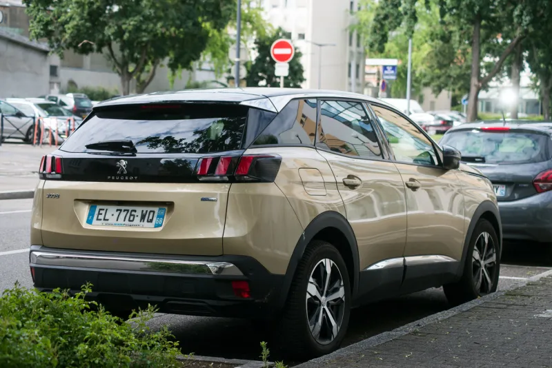 mulhouse - france - 4 june 2021 - rear view of beige peugeot 2008 suv car parked in the street