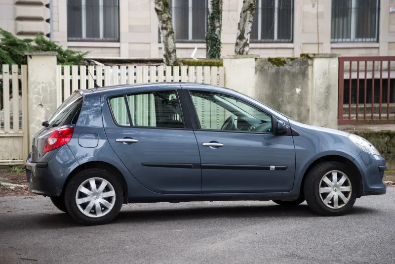 mulhouse - france - 20 march 2021 - profile view of grey renault clio parked in the street