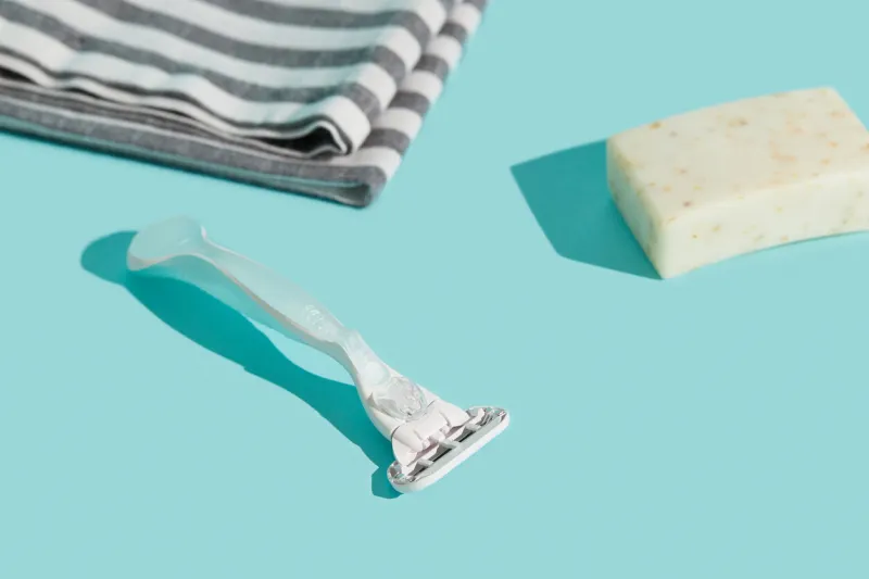 minimalist elegance  razor in sharp relief against a bold blue backdrop with dramatic shadows