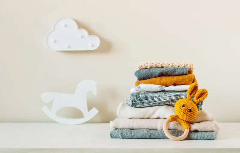 organic cotton baby clothes on the shelf in the kids room
