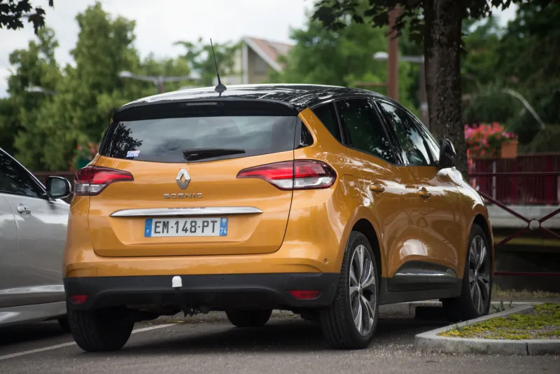 mulhouse - france - 7 june 2022 - rear view of new orange color renault scenic parked in the street