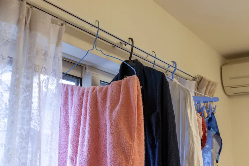 hanging laundry on the curtain rail in the room