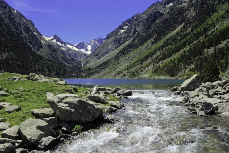 view of lac du gaube and surrounding mountains in the pyrenees, france