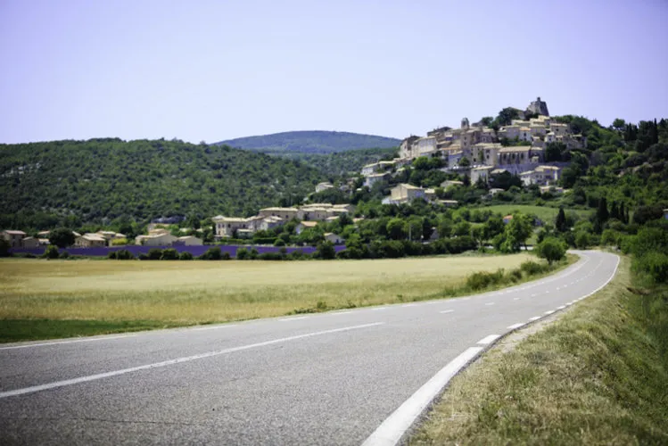 road to a small village among lavender fields - provence, france