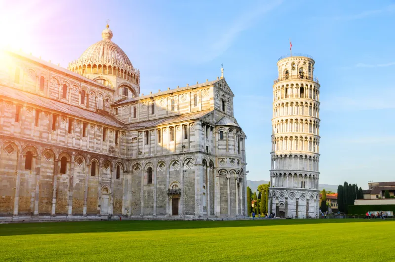 sunset view of leaning tower of pisa and cathedral, tuscany, italy