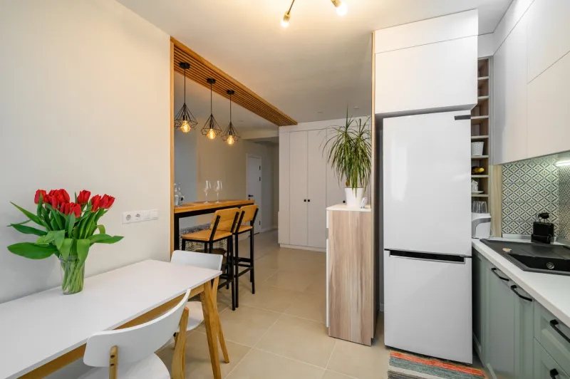 wide shot of cozy well designed teal and white modern kitchen interior