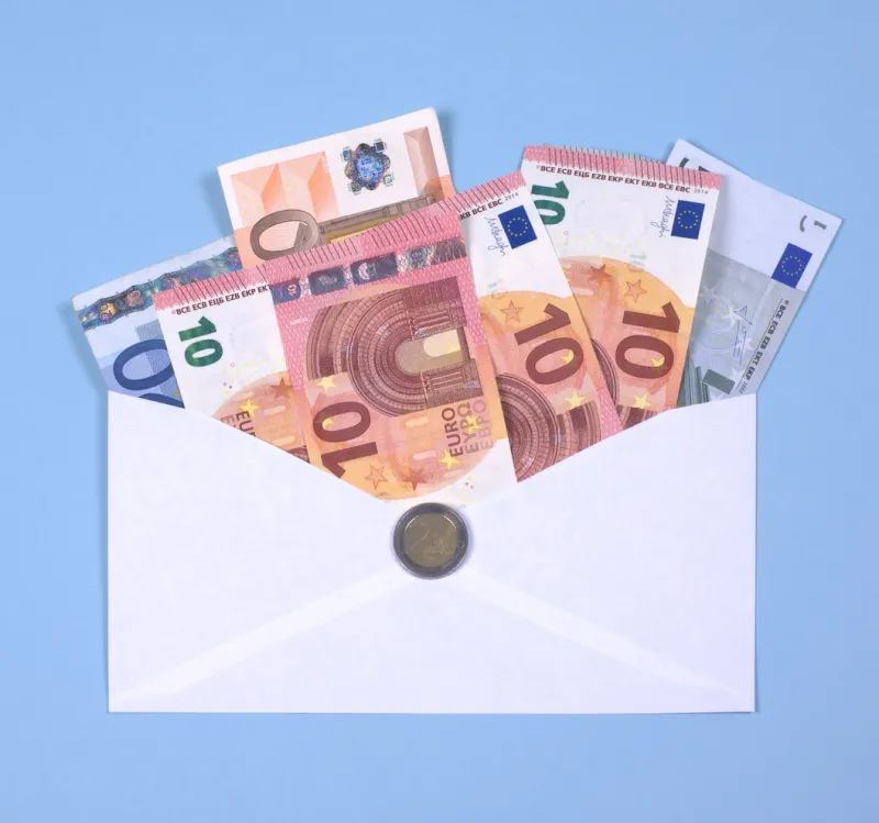 euro notes in an envelope against a blue background the money contains the in 2014 introduced new notes of ten (10) euro