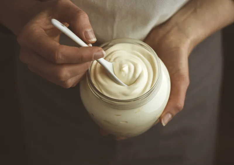 glass jar of mayonnaise with a spoon