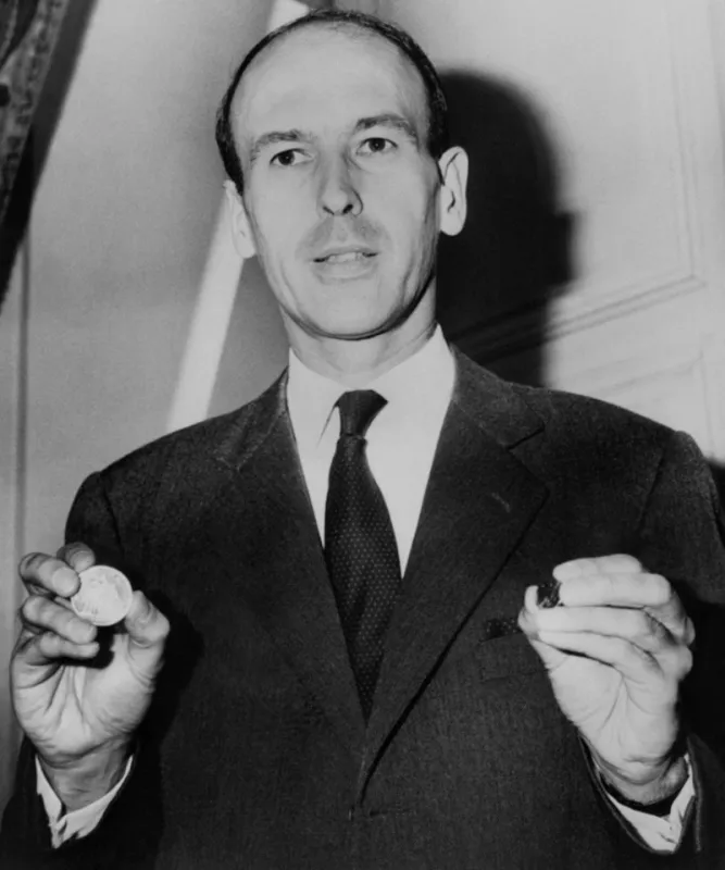 picture taken on july 17, 1964 in paris, of minister of finance and economic affairs valéry giscard d'estaing showing coins of 10 francs and half a franc (photo by stf and -   afp)
