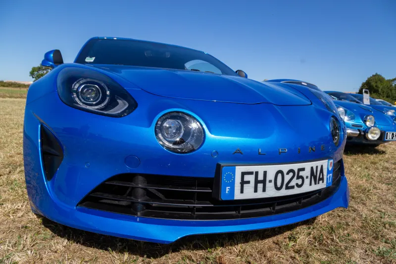 benon, france - september 9, 2020 blue new renault alpine a110 car exhibited at the tour de france in a field of small village contryside
