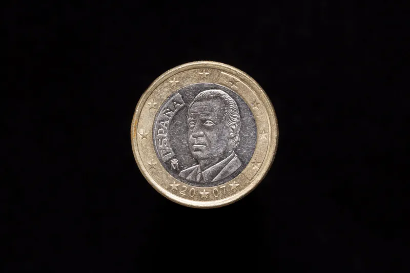 spanish 1 euro coin from 2007, obverse showing portrait of king juan carlos i isolated on black background