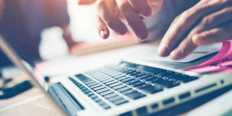 typing on laptop close-up meeting report in progress film effect, blurry background