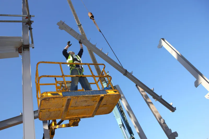 steel worker on cherry picker some motion blur on hands