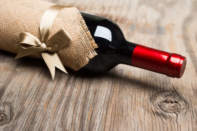 bottle of red wine for celebrating decorated on wooden background