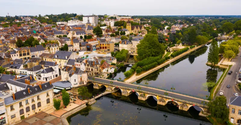 view from drone of houses and cher river at vierzon town at summer day, france