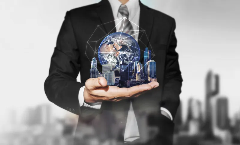 businessman holding modern buildings with global network connection elements of this image are furnished by nasa