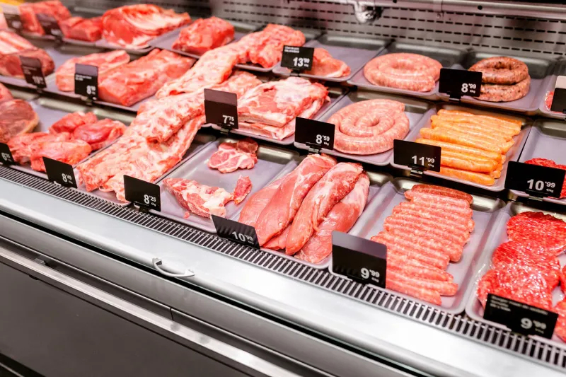 various sorts of meat on display in shop or supermarket