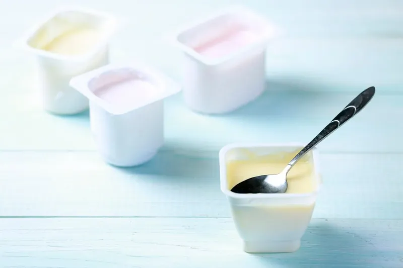 fresh youghurt in plastic pack on table closeupcolorful yogurtslight snack