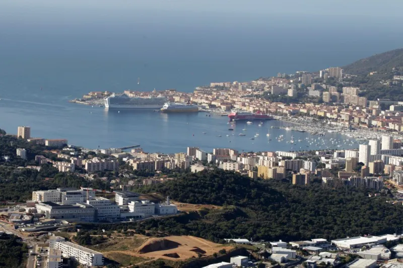 this aerial view taken on october 11, 2019 shows ajaccio city with the new hospital on the first ground (l) on the french mediterranean island of corsica (photo by pascal pochard-casabianca   afp)