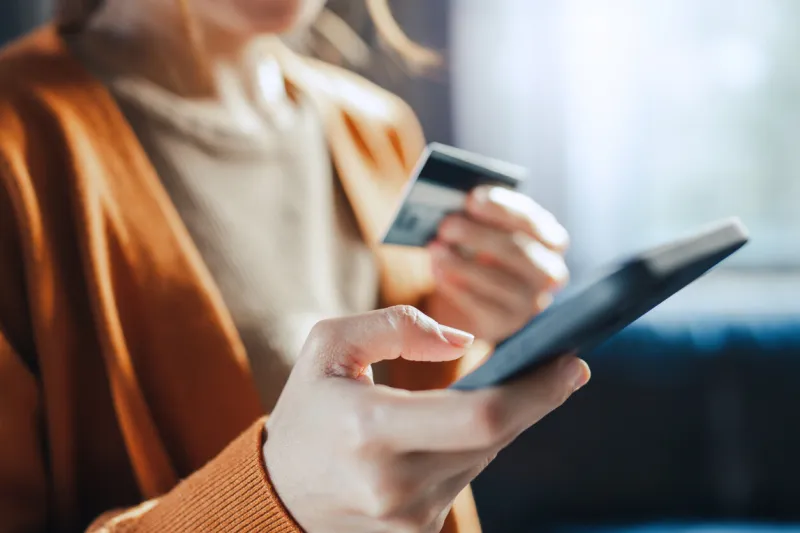 online payment, hands of woman holding a credit card and using smart phone for online shopping