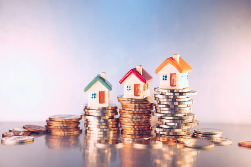 miniature colorful house on stack coins using as property and financial concept