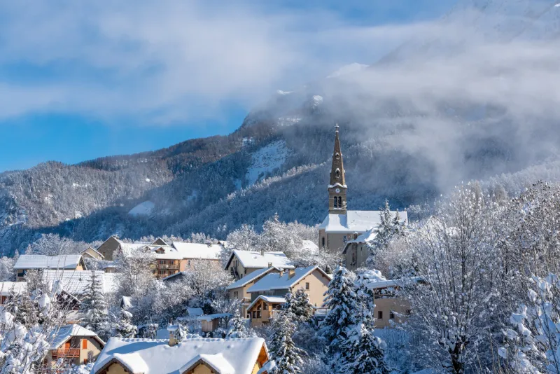 the village of saint leger les melezes in the champsaur valley covered in snow in winter ski resort in the ecrins national park, french alps, hautes alpes, france