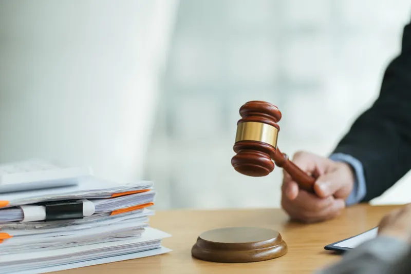 justice and law conceptmale judge in a courtroom on wooden table and counselor or male lawyer working in office legal law, advice and justice concept