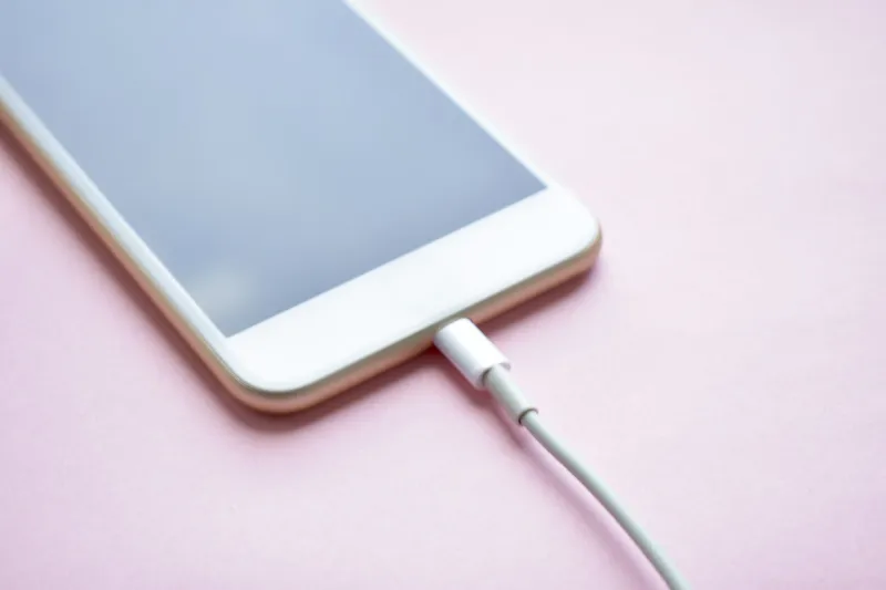 charging a mobile phone connected to electricity for rechargingcopy space