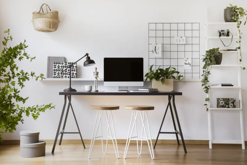 desktop computer mock-up on an industrial desk in a scandinavian student bedroom interior workspace with white walls
