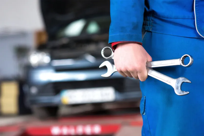 hand of car mechanic with wrench auto repair garage