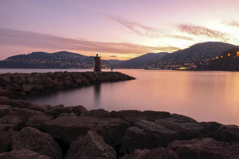 the entrance of the mandelieu-la-napoule marina with an incredible sunset on the background mountains