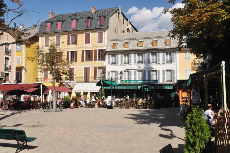 barcelonnette, france - september 17, 2011  village square, the dwellers and some tourist enjoy the open air on a sunny end of summer saturday morning