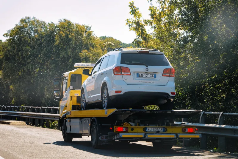 rome, italy - october 4, 2017  tow truck with a car on the road