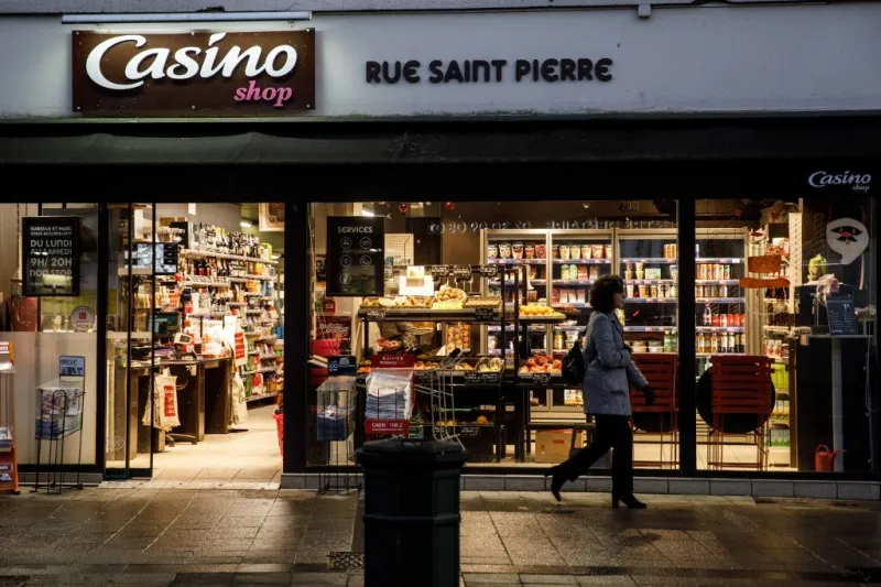 a woman walks in front of a casino supermarket in the city of caen, northwestern of france, on november 29, 2019 (photo by sameer al-doumy   afp)