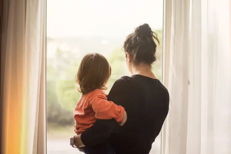 mother and son looking out of window