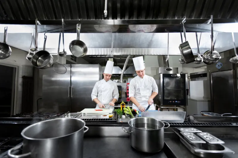 chefs prepare meals in the kitchen