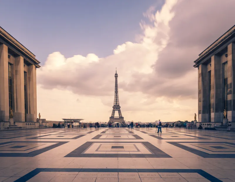 eiffel tower, paris symbol and iconic landmark in france, on a cloudy day famous touristic places and romantic travel destinations in europe cityscape and tourism concept long exposure toned