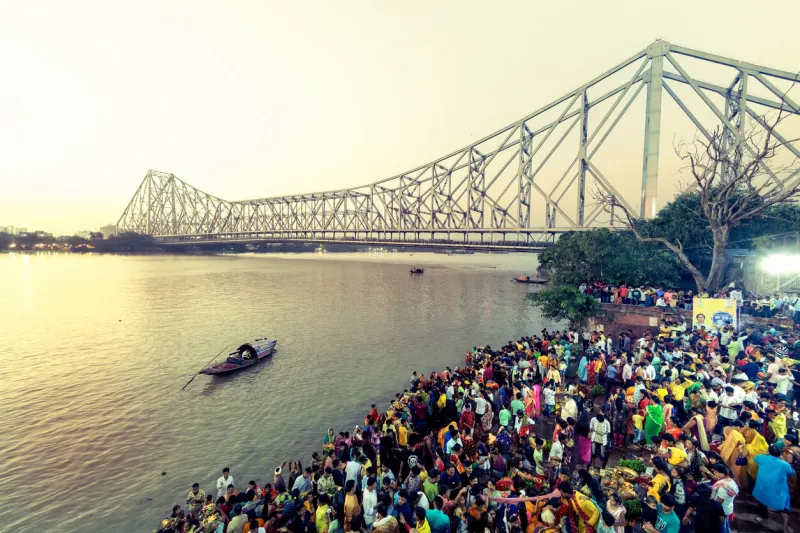 evening view of howrah bridge during chhath puja people are doing their rituals at gangs ghat near howrah bridge location  howrah bridge, kolkata, west bengal, india date 30th october