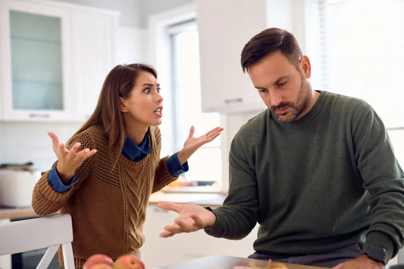 angry woman having discussion with her husband at home