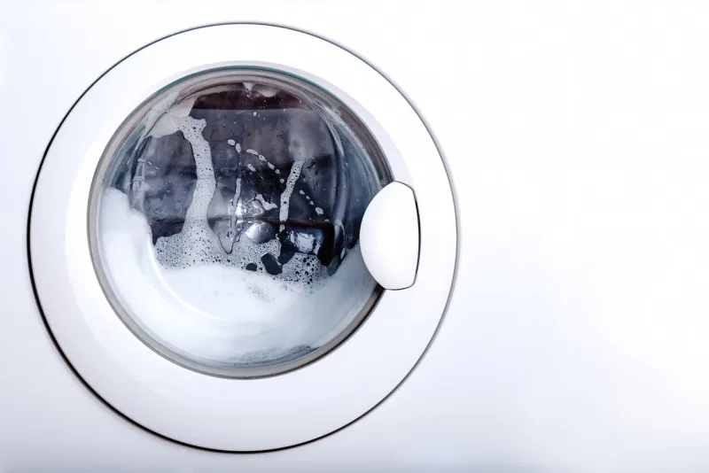 the washing machine is in the process of washing copy space