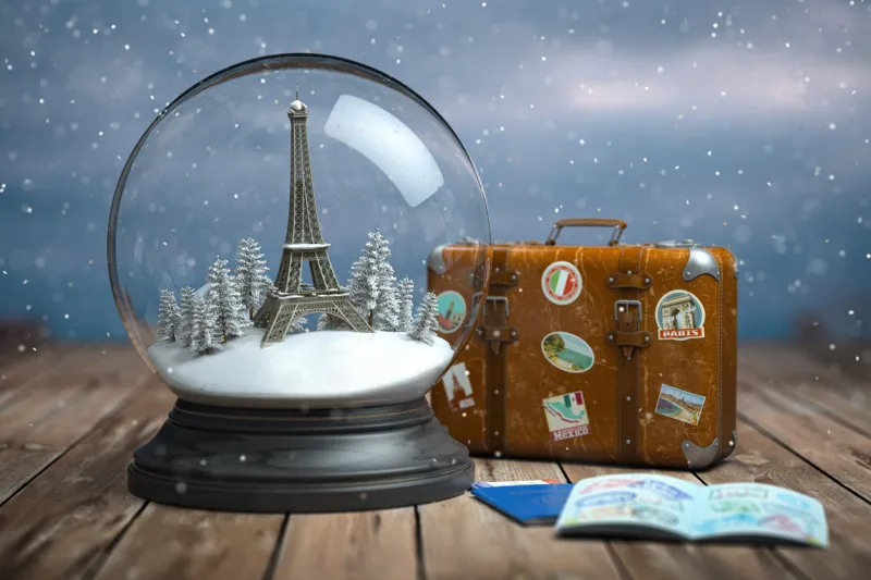 eiffel tower in the snow globe, vintage suitcase and passports with visa stamp travel or trip to paris and france in winter for celebrate christmas 3d illustration