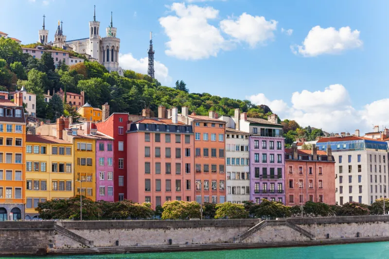 scenic view of st georges district of old lyon with its color houses and basilica of notre-dame de fourviere on the background