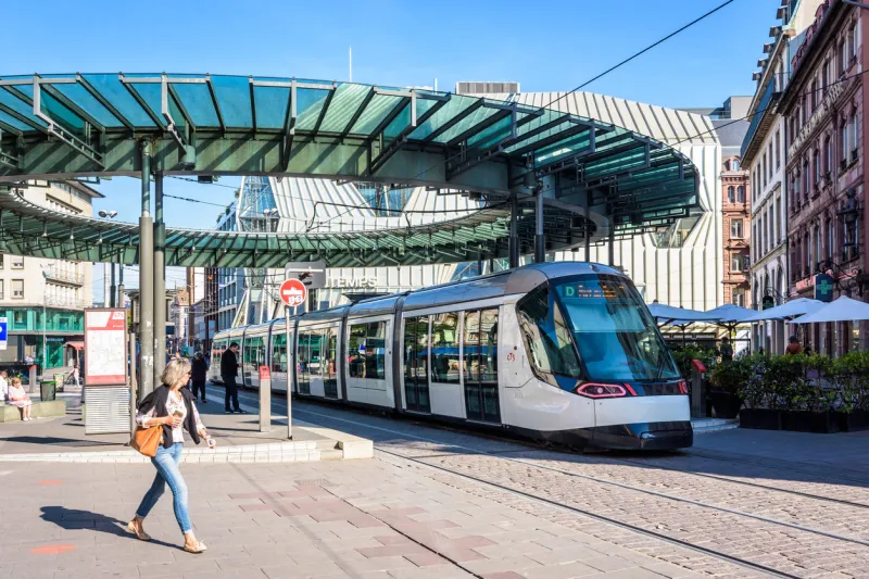 strasbourg, france - september 15, 2019  a citadis streetcar from line d is stationing at the tram station homme de fer, the busiest station of the cts network, topped by a glass rotunda