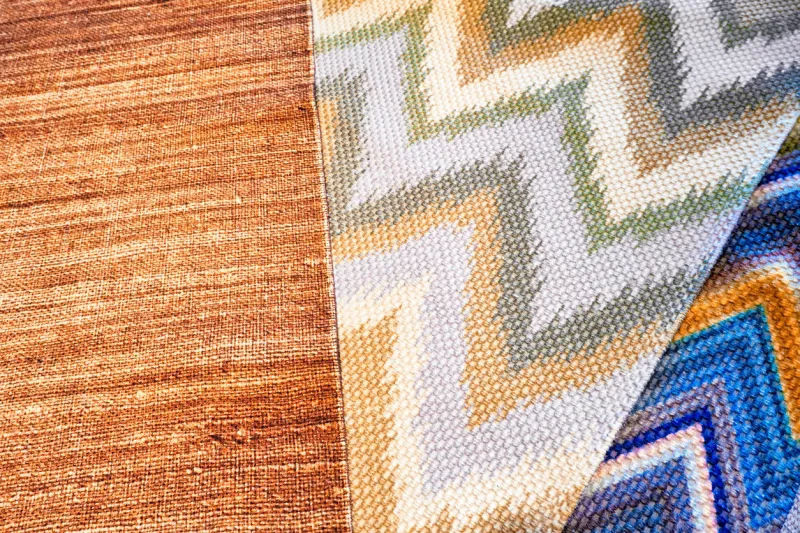 sample of carpets or rugs on display in a carpet store